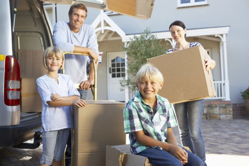 Family moving items into secure household storage in Leabridge