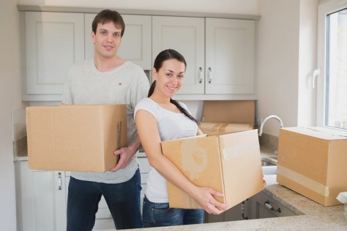Furniture being moved through a Leabridge apartment corridor